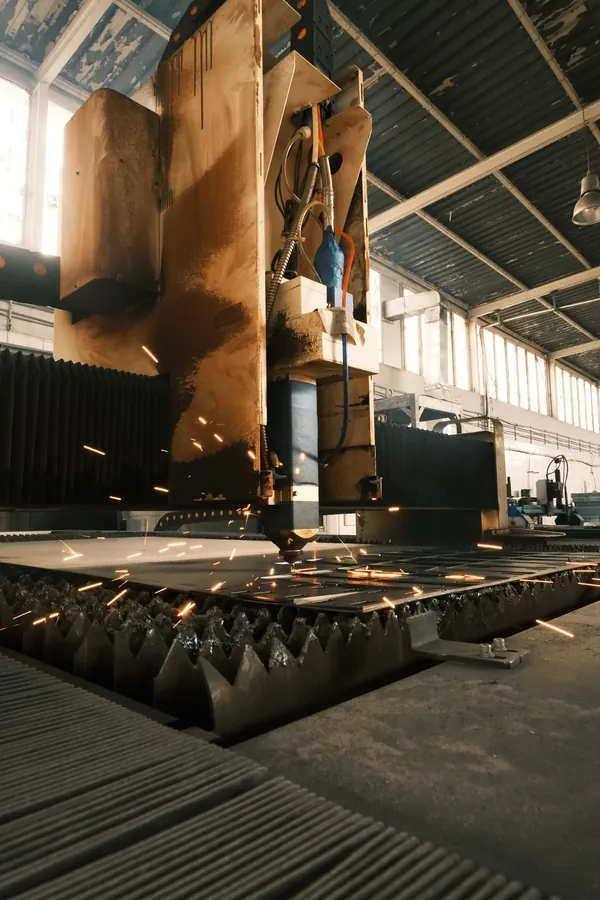 Sparks flying from a cutting machine on a factory floor